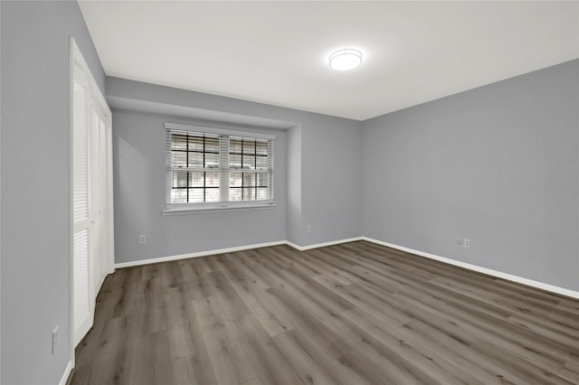 spare room with wood-type flooring