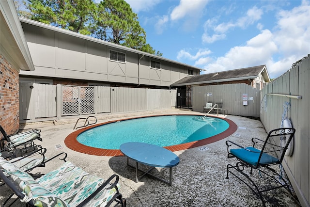 view of swimming pool featuring a patio area