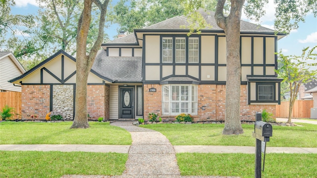 english style home featuring a front lawn