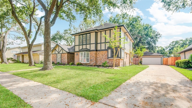 view of front of home featuring a garage, an outdoor structure, and a front lawn