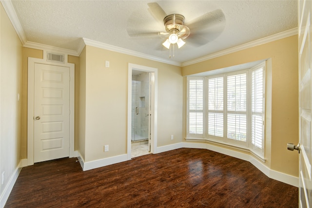 unfurnished bedroom with crown molding, ensuite bath, a textured ceiling, dark hardwood / wood-style floors, and ceiling fan