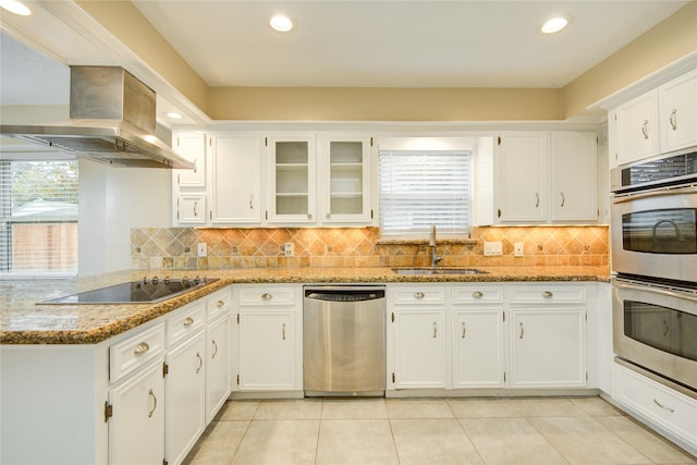 kitchen with light stone countertops, white cabinets, sink, and stainless steel appliances