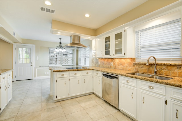 kitchen with light stone counters, extractor fan, sink, white cabinets, and stainless steel dishwasher