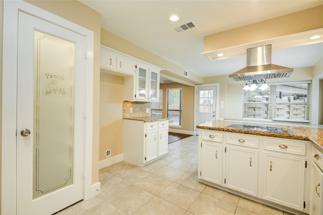 kitchen featuring white cabinetry, extractor fan, black electric cooktop, and light stone counters