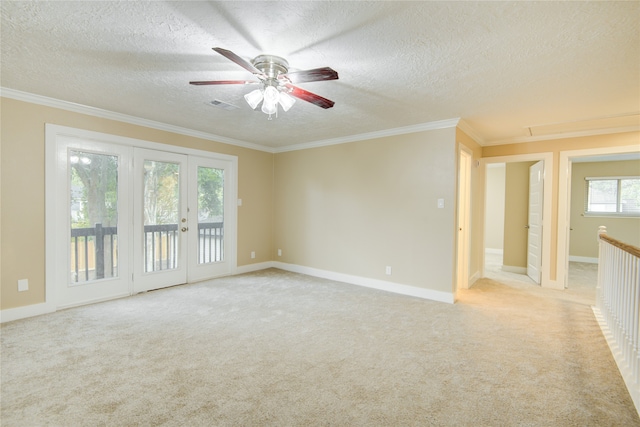 unfurnished room featuring a textured ceiling, light colored carpet, and ornamental molding