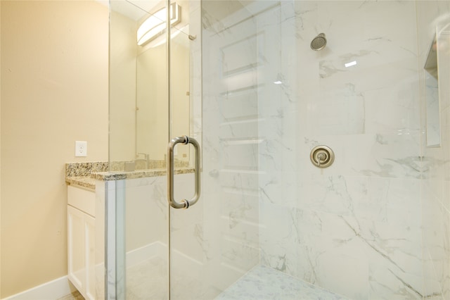 bathroom featuring walk in shower and vanity