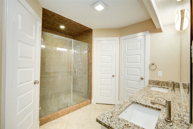 bathroom with vanity, walk in shower, and tile patterned floors