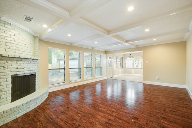 unfurnished living room with hardwood / wood-style flooring, beam ceiling, a textured ceiling, and crown molding