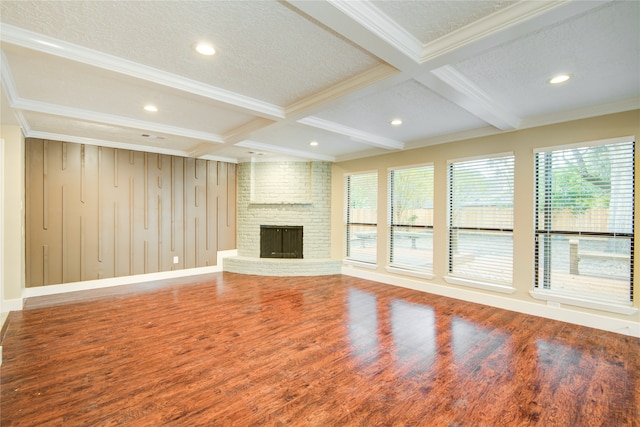 unfurnished living room with hardwood / wood-style flooring, beamed ceiling, a textured ceiling, a fireplace, and coffered ceiling