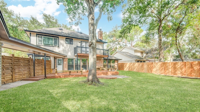 back of property featuring a patio, a balcony, and a yard