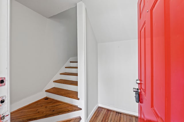 foyer with lofted ceiling and hardwood / wood-style flooring