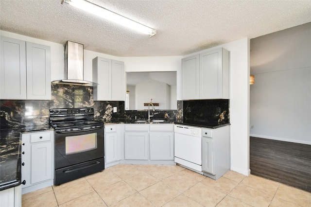 kitchen with light hardwood / wood-style floors, dishwasher, sink, black range with electric stovetop, and wall chimney range hood