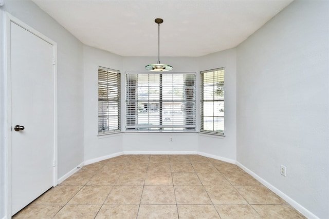 unfurnished dining area with light tile patterned floors