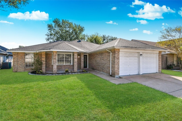 ranch-style house featuring a garage, cooling unit, and a front yard