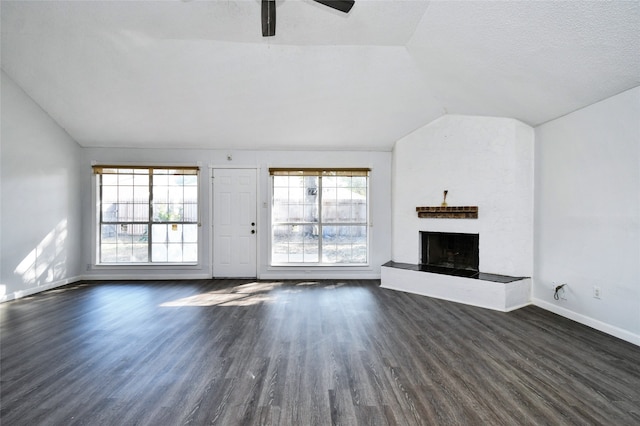 unfurnished living room with vaulted ceiling, ceiling fan, a textured ceiling, and dark hardwood / wood-style flooring