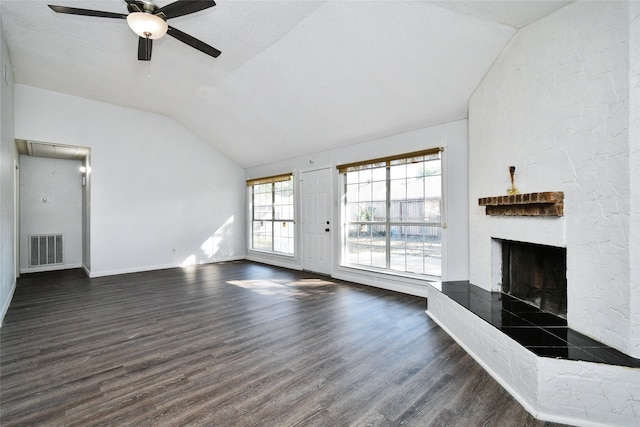 unfurnished living room with dark wood-type flooring, ceiling fan, a textured ceiling, and lofted ceiling