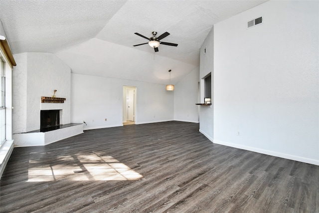 unfurnished living room with dark hardwood / wood-style flooring, ceiling fan, a textured ceiling, and vaulted ceiling