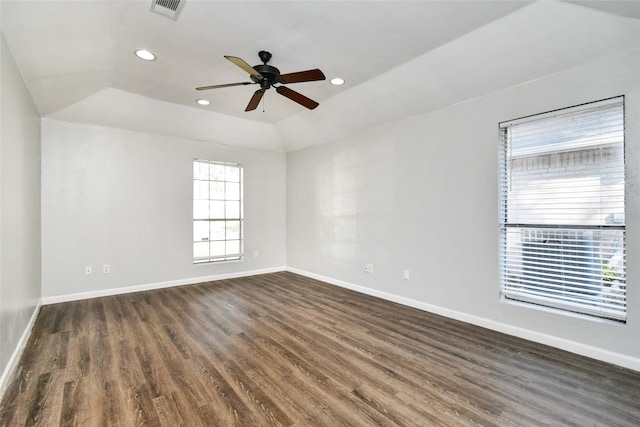 empty room with ceiling fan, dark hardwood / wood-style floors, and vaulted ceiling