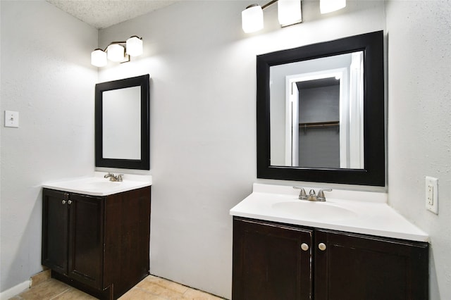 bathroom with vanity and a textured ceiling