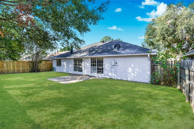 rear view of house featuring a patio area and a yard