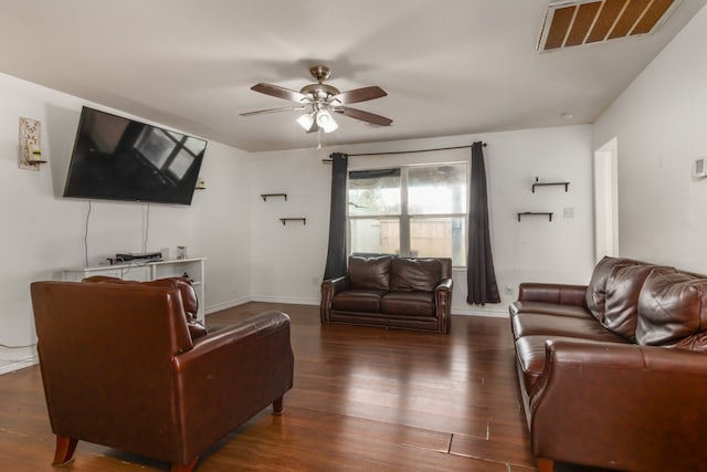 living room featuring dark hardwood / wood-style floors and ceiling fan