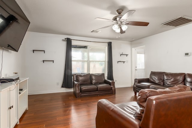 living room with ceiling fan and dark hardwood / wood-style floors