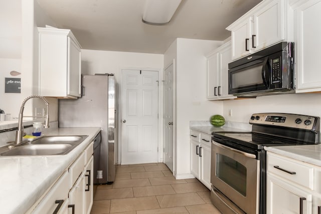 kitchen featuring white cabinetry, appliances with stainless steel finishes, sink, and light tile patterned floors