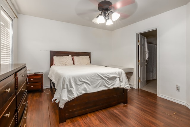 bedroom with ensuite bath, ceiling fan, and dark hardwood / wood-style floors