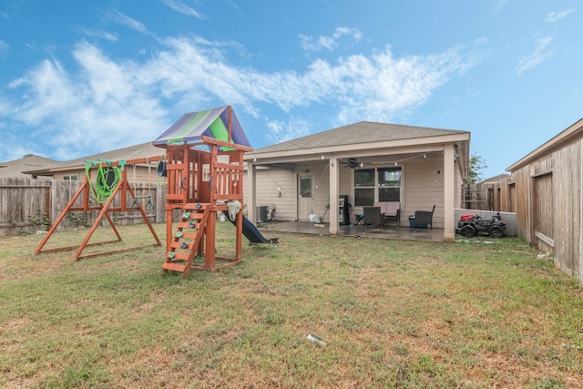 view of play area featuring ceiling fan, a lawn, cooling unit, and a patio