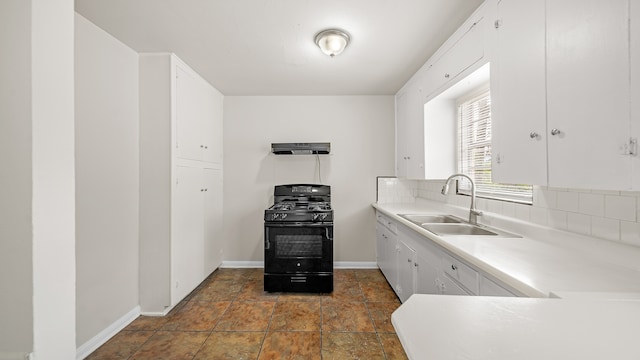 kitchen with white cabinetry, sink, black gas range, and decorative backsplash