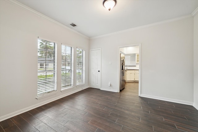 empty room with crown molding and dark hardwood / wood-style flooring