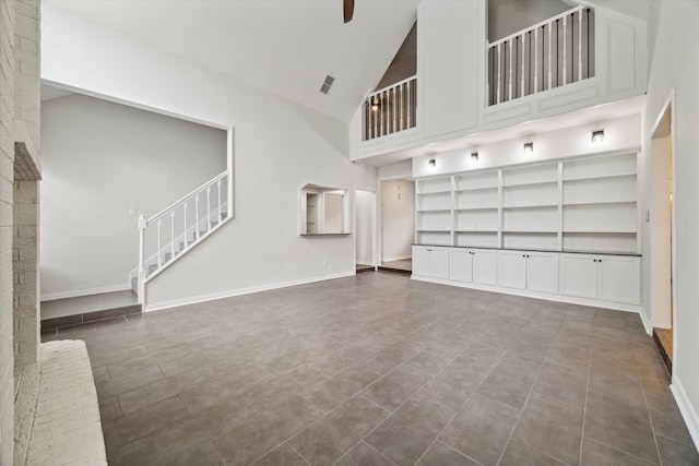 unfurnished living room with high vaulted ceiling