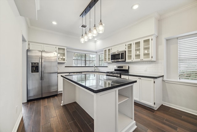 kitchen featuring white cabinetry, appliances with stainless steel finishes, dark wood-type flooring, and a kitchen island