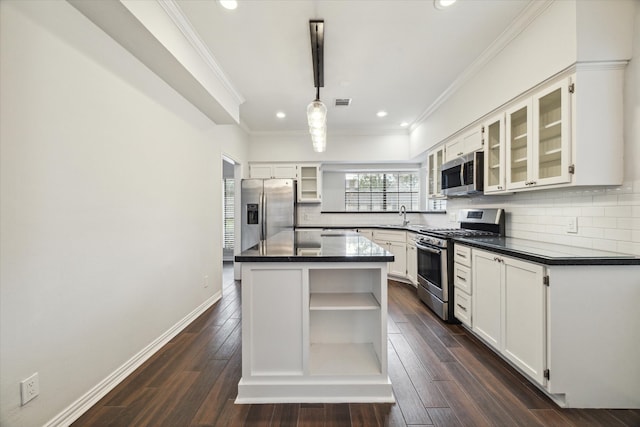 kitchen featuring dark hardwood / wood-style flooring, white cabinetry, a center island, and stainless steel appliances