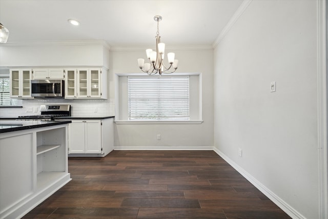 kitchen with white cabinets, stainless steel appliances, a healthy amount of sunlight, and decorative light fixtures