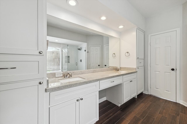 bathroom with walk in shower, vanity, and hardwood / wood-style flooring