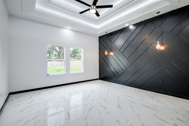 unfurnished room featuring ceiling fan, crown molding, and a raised ceiling