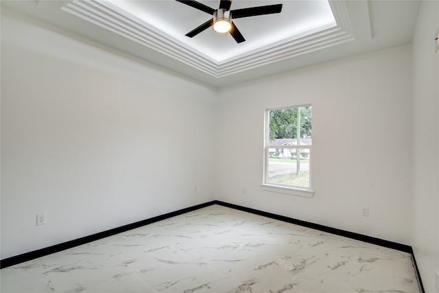 spare room featuring ceiling fan and a tray ceiling