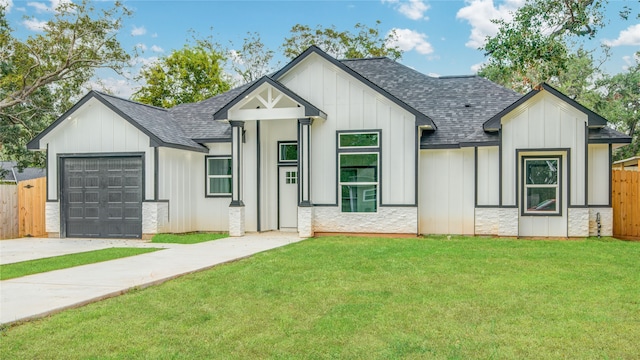 modern inspired farmhouse with a garage and a front yard