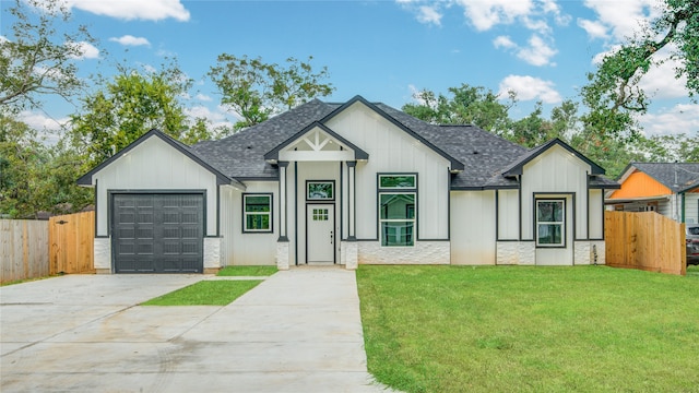 modern farmhouse style home featuring a front lawn and a garage