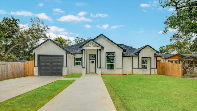 modern inspired farmhouse featuring a garage and a front yard