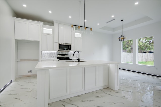 kitchen with decorative backsplash, hanging light fixtures, a large island, and stainless steel appliances