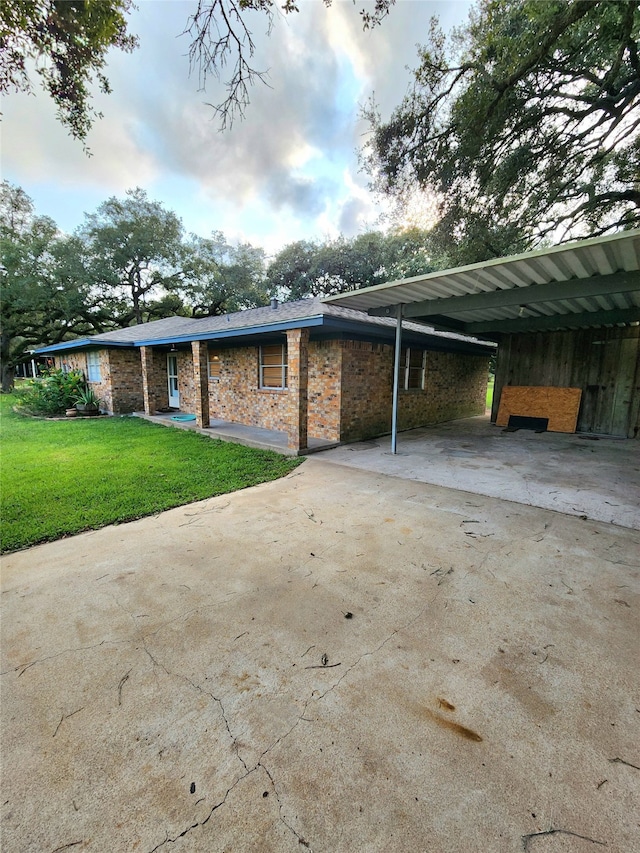 exterior space with a lawn and a carport