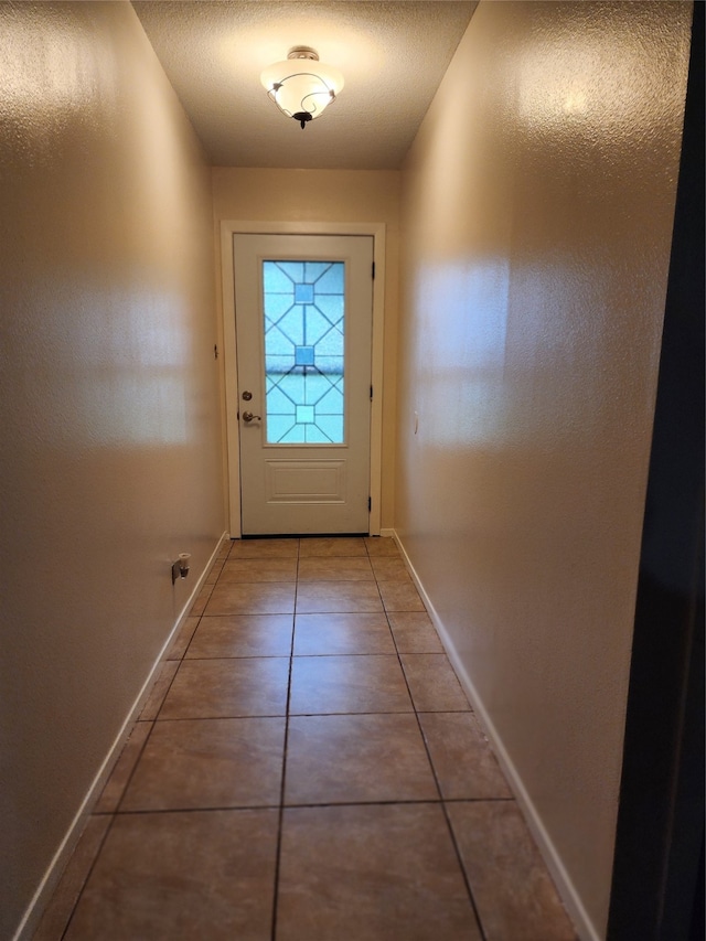 doorway to outside featuring tile patterned flooring