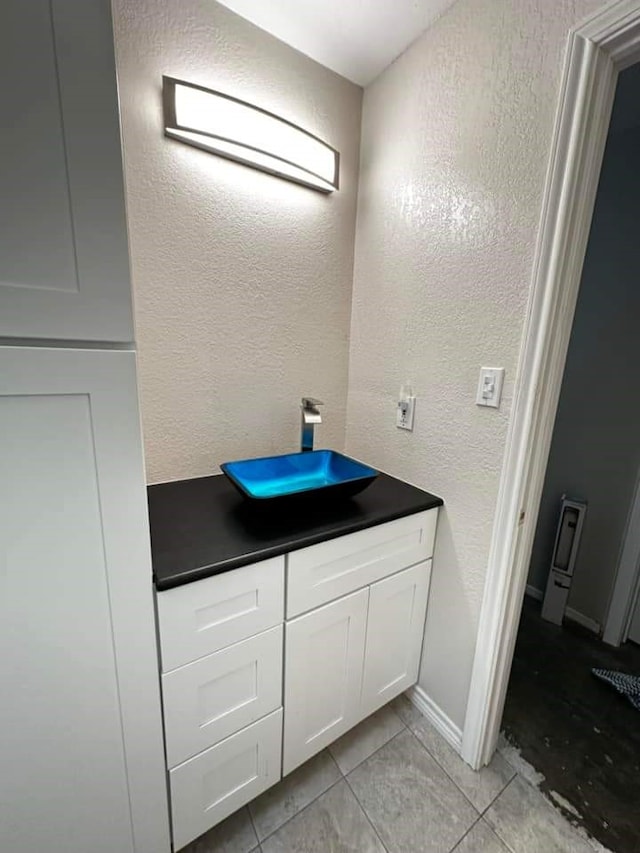 bathroom with tile patterned flooring and vanity