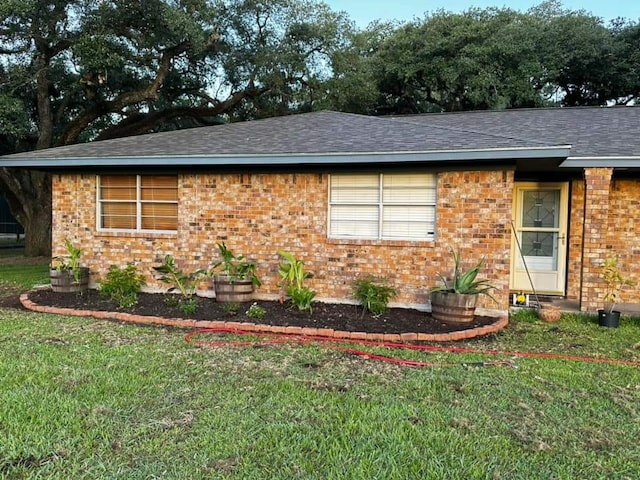 view of side of property with a lawn