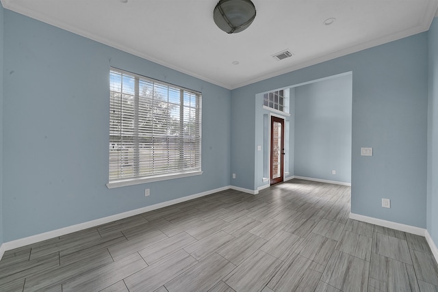 spare room featuring ornamental molding