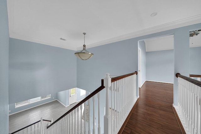 corridor with dark wood-type flooring and ornamental molding