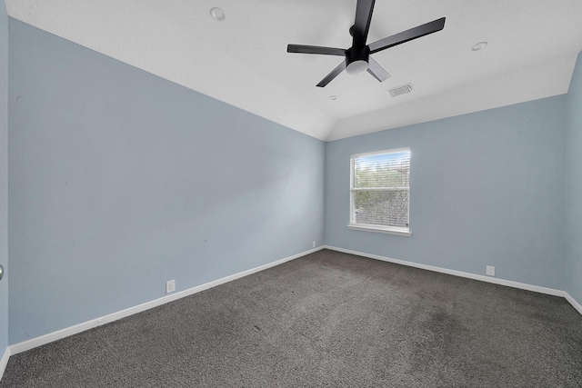 carpeted spare room featuring vaulted ceiling and ceiling fan