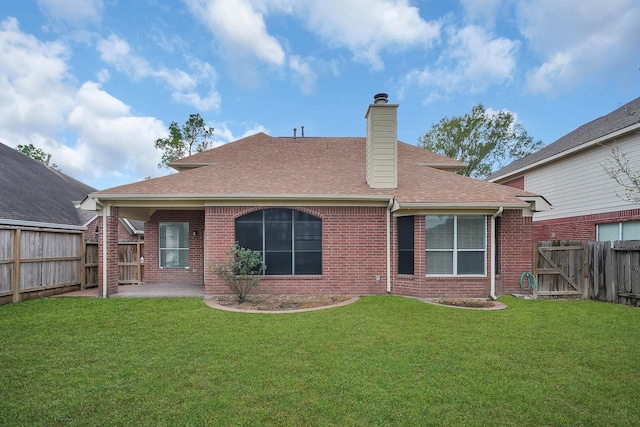 rear view of property featuring a patio and a lawn